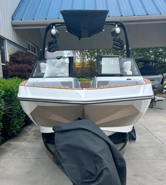 Slide: The Image of 2023 Nautique Super Air Nautique GS22 boat with sleek design, parked outdoors. - 3