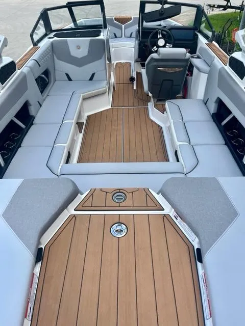 Slide: The Image of 2023 Nautique Super Air Nautique GS22 interior with sleek seating and modern dashboard. - 7