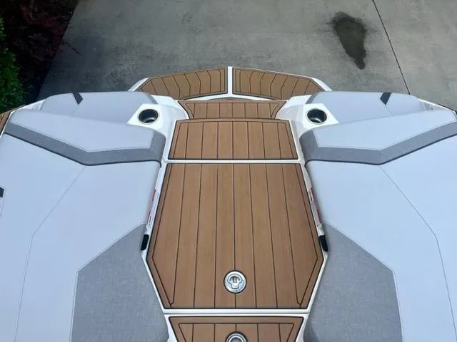 Slide: The Image of 2023 Nautique Super Air Nautique GS22 boat deck with sleek design and wood finish. - 8