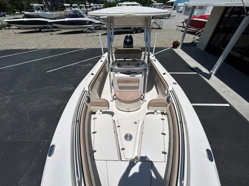 Slide: The Image of 2023 Sea Chaser 22 HFC boat, spacious deck, parked outdoors, surrounded by other boats. - 15