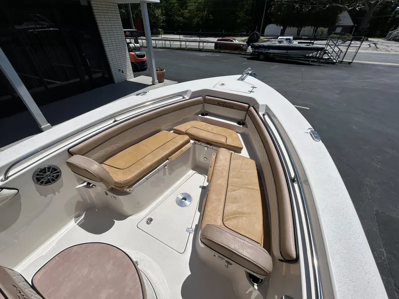 Slide: The Image of 2023 Sea Chaser 22 HFC boat with tan seating and spacious deck area. - 17
