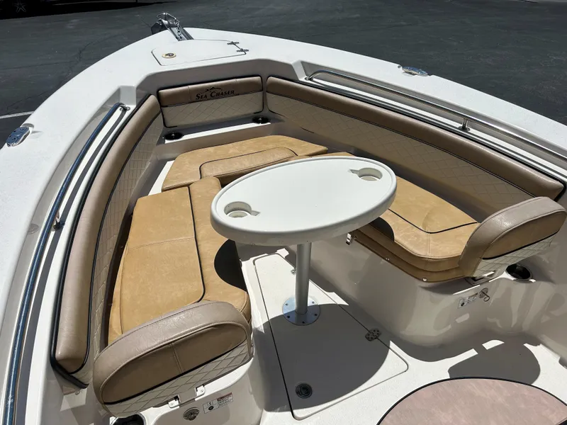 Slide: The Image of 2023 Sea Chaser 22 HFC boat interior with tan seating and round table. - 20