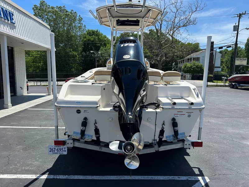 Slide: The Image of 2023 Sea Chaser 22 HFC boat, rear view with outboard motor, parked in a lot. - 5