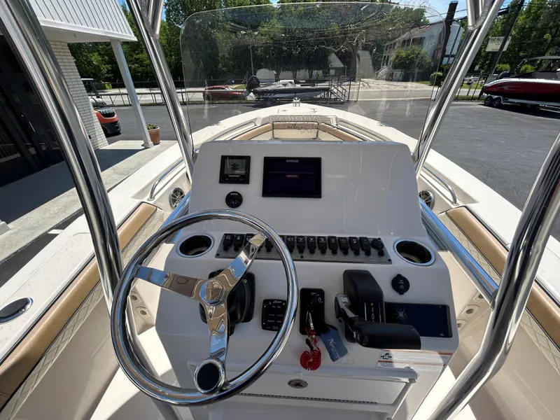 Slide: The Image of 2023 Sea Chaser 22 HFC boat dashboard with steering wheel and control panel. - 8