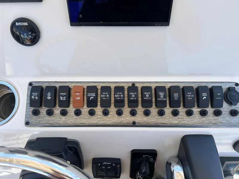 Slide: The Image of Control panel of 2023 Sea Chaser 22 HFC boat with various switches and instruments. - 9