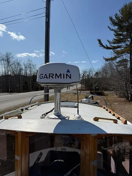 Slide: The Image of Glen-L BO-JEST 1999 boat with Garmin radar, parked near a road and trees. - 14