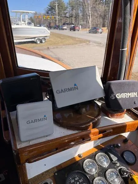 Slide: The Image of Garmin navigation devices on a 1999 Glen-L BO-JEST boat dashboard. - 16
