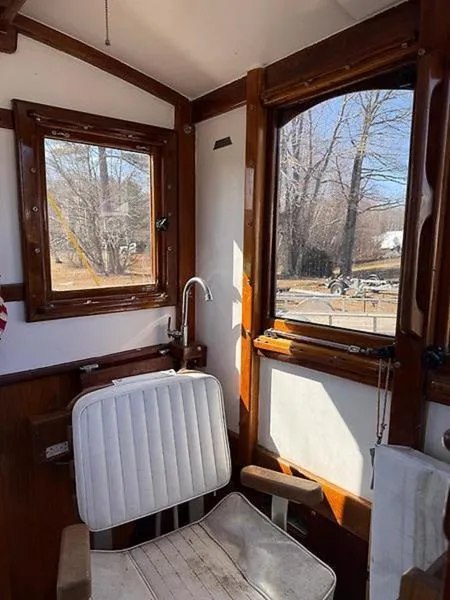 Slide: The Image of Interior of 1999 Glen-L BO-JEST boat with wooden trim and white seating. - 17