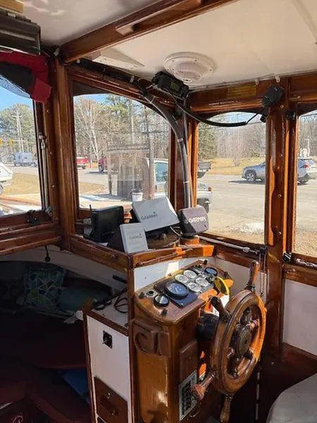 Slide: The Image of Interior of a 1999 Glen-L BO-JEST boat with wooden helm and navigation equipment. - 18