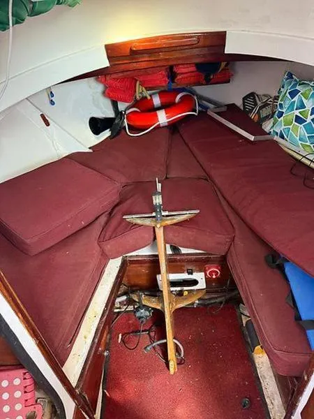 Slide: The Image of Cozy interior of 1999 Glen-L BO-JEST boat with red cushions and nautical decor. - 19