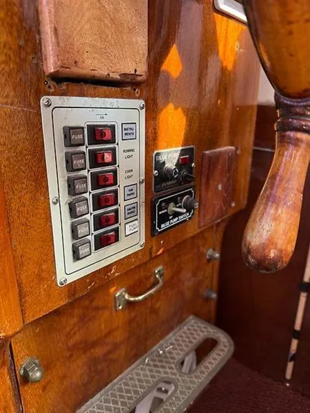 Slide: The Image of Control panel of a 1999 Glen-L BO-JEST boat with switches and wooden finish. - 22