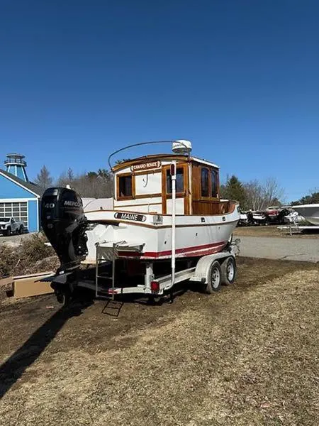 Slide: The Image of 1999 Glen-L BO-JEST boat on trailer with outboard motor, parked outdoors. - 3