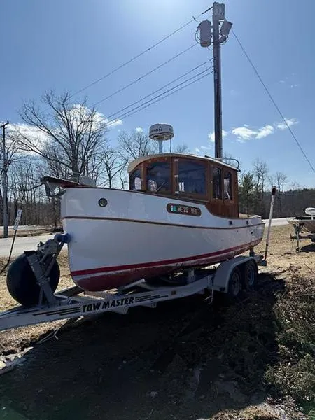 Slide: The Image of 1999 Glen-L BO-JEST boat on trailer, parked outdoors under clear sky. - 4
