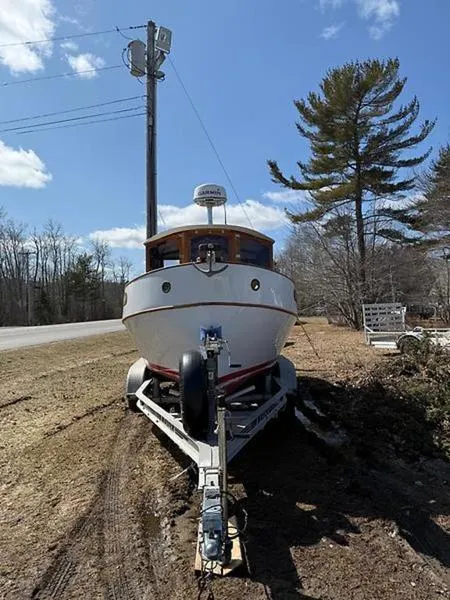 Slide: The Image of 1999 Glen-L BO-JEST boat on trailer, parked roadside, surrounded by trees and clear sky. - 6