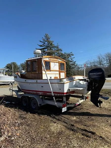 Slide: The Image of 1999 Glen-L BO-JEST boat on trailer with Mercury outboard motor, parked outdoors. - 7