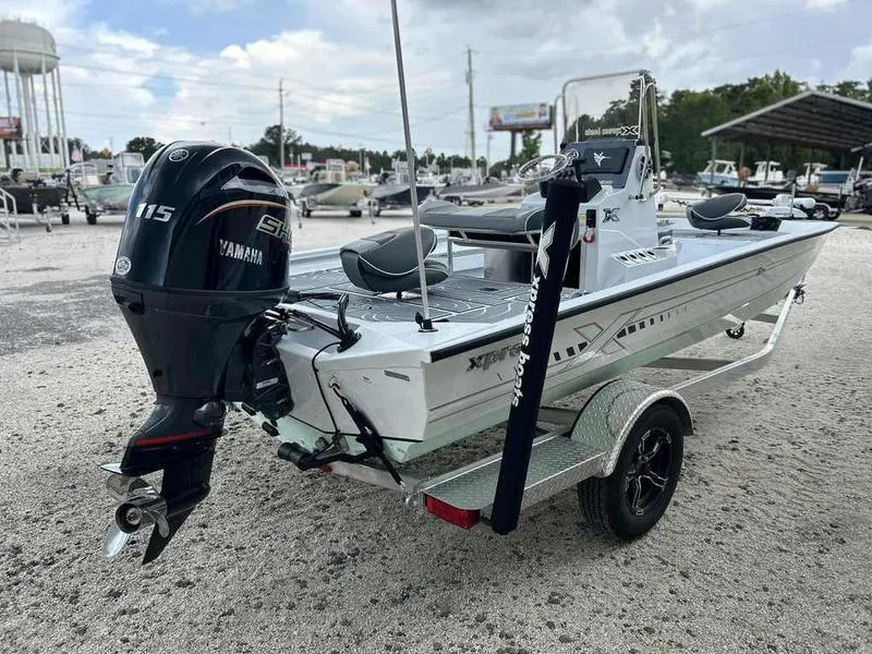 Slide: The Image of 2025 Xpress H20 BAY boat with Yamaha 115 engine on a trailer. - 13