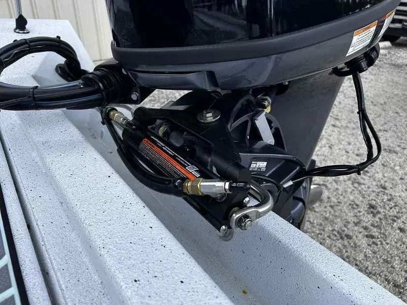 Slide: The Image of 2025 Xpress H20 BAY boat engine close-up, showcasing hydraulic steering components. - 14