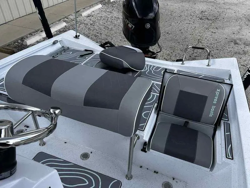 Slide: The Image of 2025 Xpress H20 BAY boat interior with gray seating and steering wheel. - 9