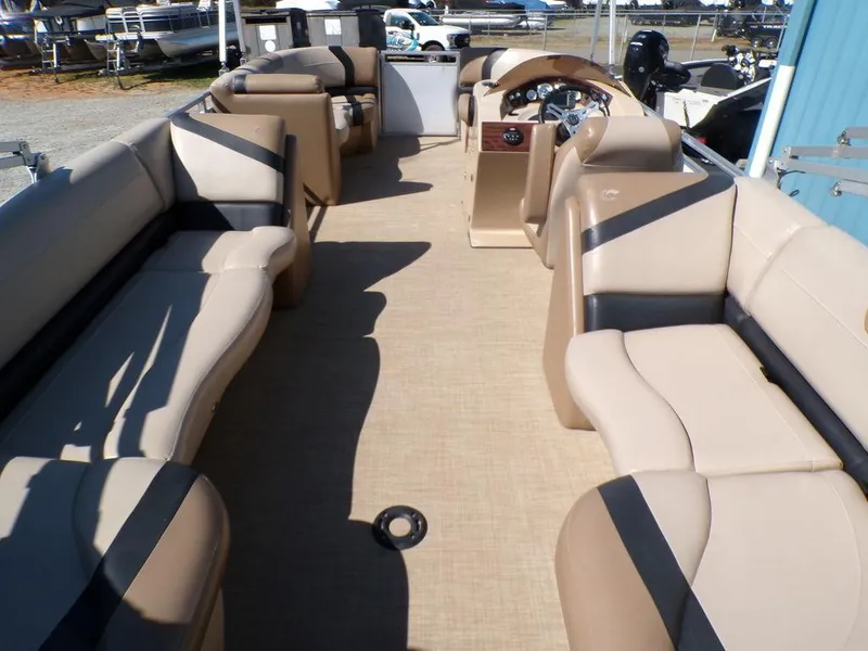 Slide: The Image of 2018 Crestliner 220 RALLY pontoon boat interior with beige seating and steering console. - 11