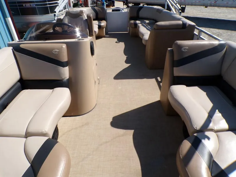 Slide: The Image of 2018 Crestliner 220 RALLY pontoon boat interior with beige seating and spacious layout. - 13
