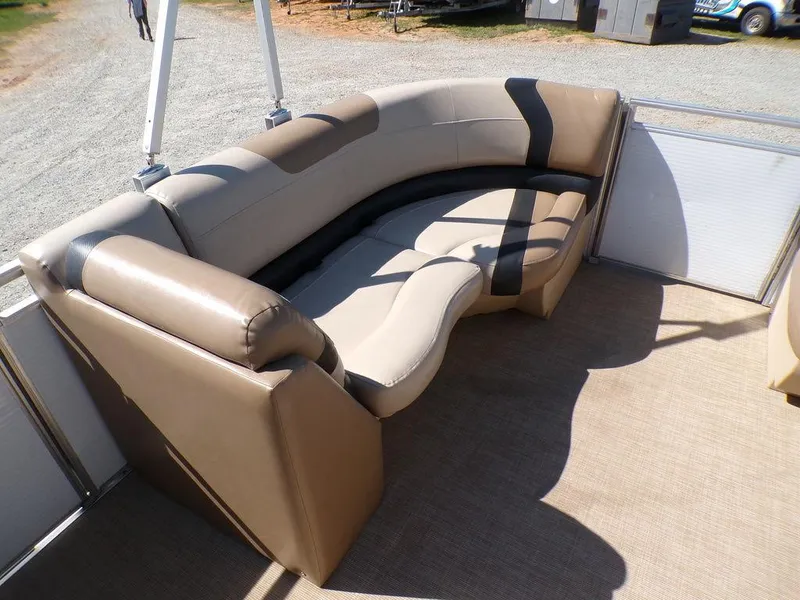 Slide: The Image of 2018 Crestliner 220 RALLY boat interior with curved beige seating and carpeted floor. - 14