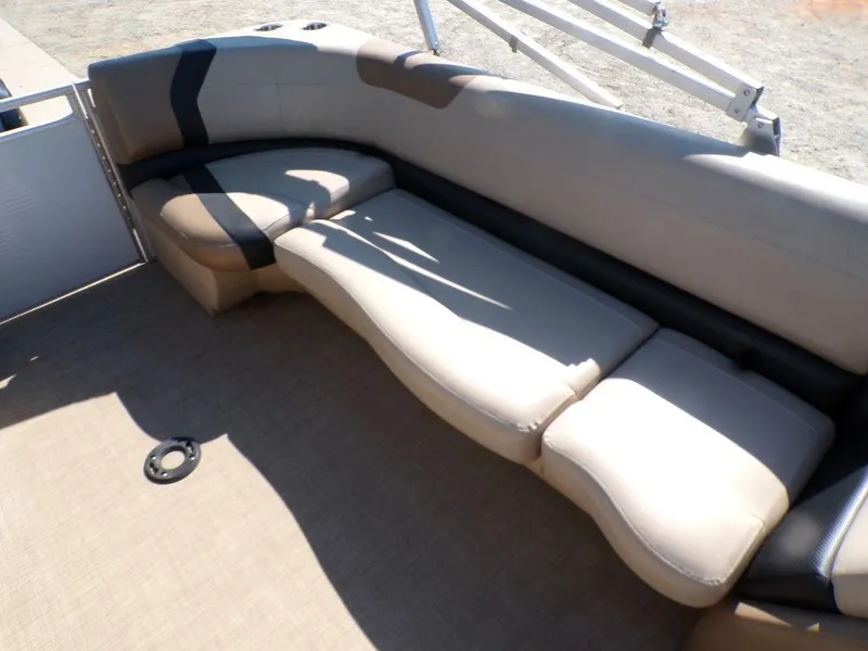 Slide: The Image of 2018 Crestliner 220 RALLY boat interior with beige and black cushioned seating. - 2