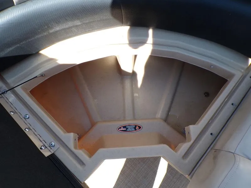 Slide: The Image of 2018 Crestliner 220 RALLY storage compartment with beige interior and black trim. - 4