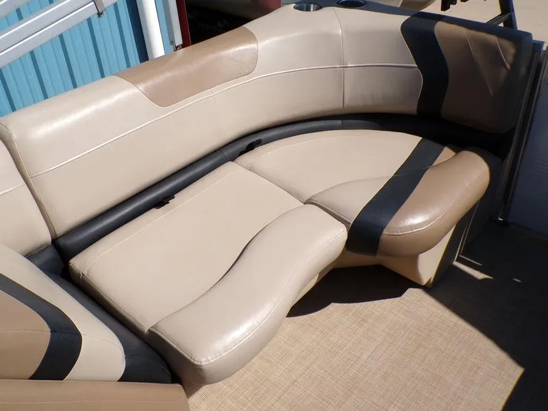 Slide: The Image of 2018 Crestliner 220 RALLY boat interior with beige and black cushioned seating. - 5