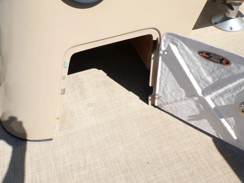 Slide: The Image of Open storage compartment on 2018 Crestliner 220 RALLY boat with beige interior. - 6