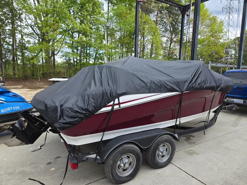 Slide: The Image of 2019 Tahoe 500 TF boat covered on trailer, parked outdoors. - 11