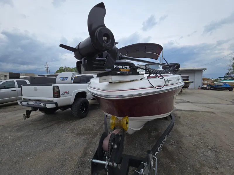 Slide: The Image of 2019 Tahoe 500 TF boat on trailer with Minn Kota motor, parked beside a white truck. - 12