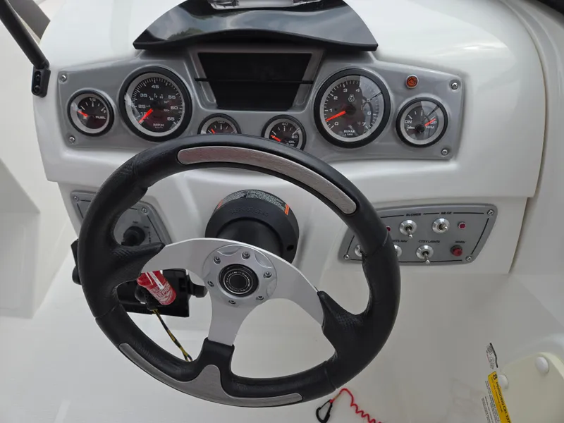 Slide: The Image of Steering wheel and dashboard of 2019 Tahoe 500 TF boat with gauges and controls. - 30