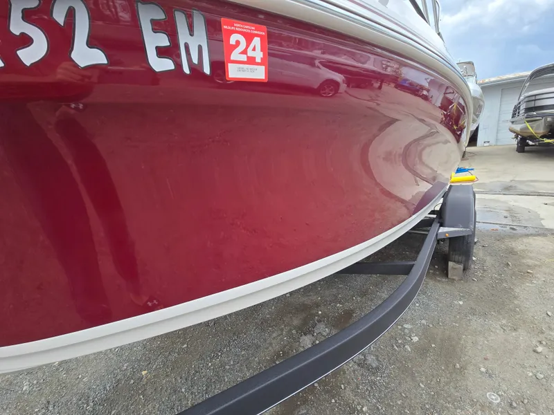 Slide: The Image of Red 2019 Tahoe 500 TF boat on trailer, registration sticker visible. - 4