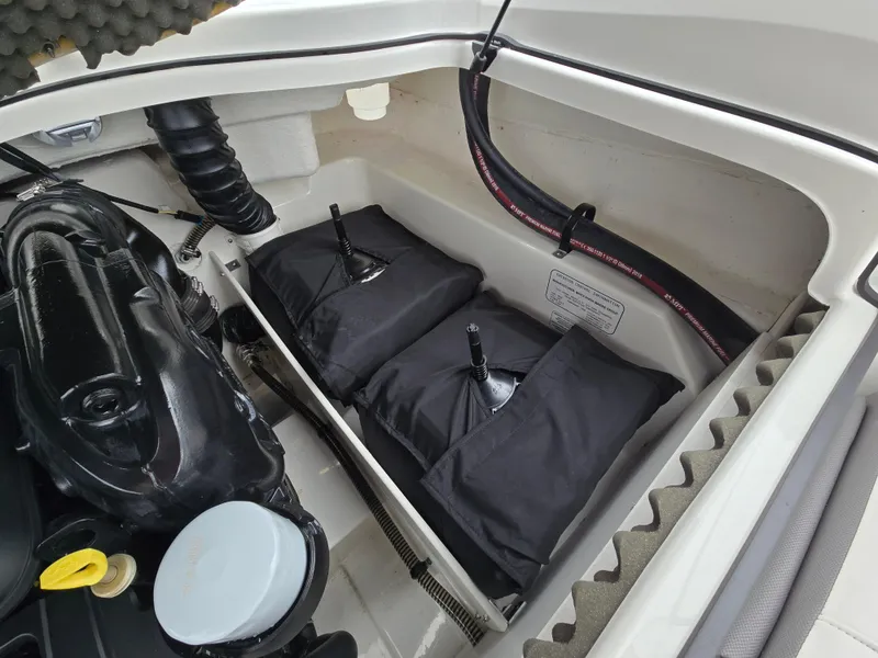 Slide: The Image of Engine compartment of 2019 Tahoe 500 TF boat with storage bags and hoses. - 41