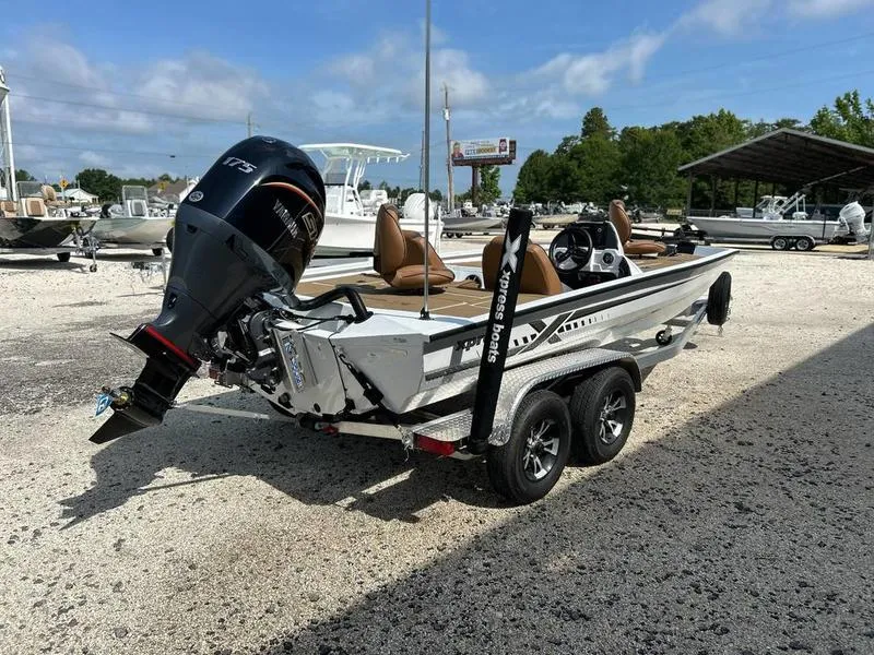 Slide: The Image of 2025 Xpress H20 Crappie boat with powerful outboard motor on a trailer. - 1