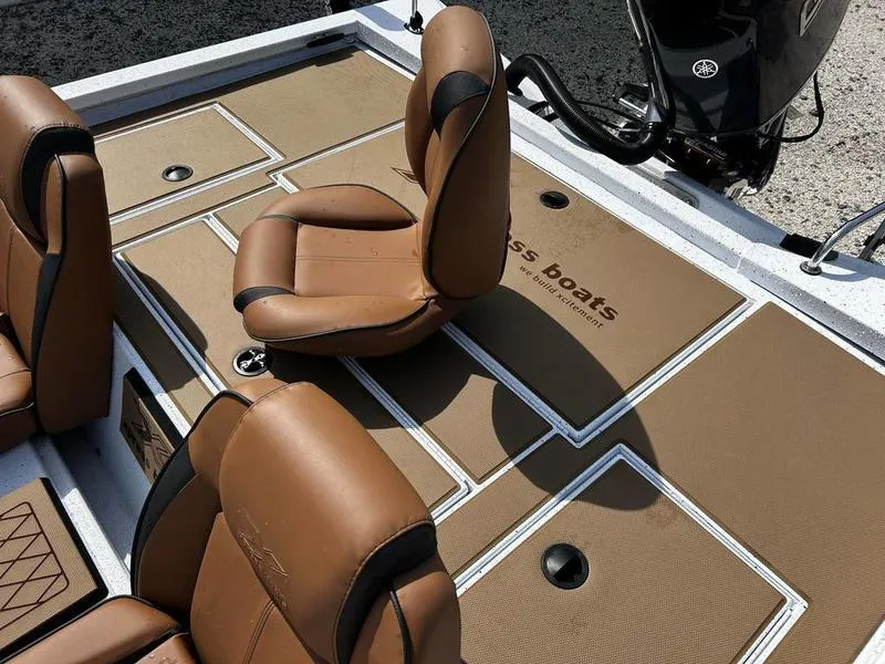 Slide: The Image of 2025 Xpress H20 Crappie boat interior with brown seats and storage compartments. - 16