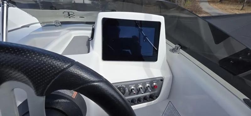 Slide: The Image of 2025 Tahoe T16 boat dashboard with steering wheel and control panel. - 10