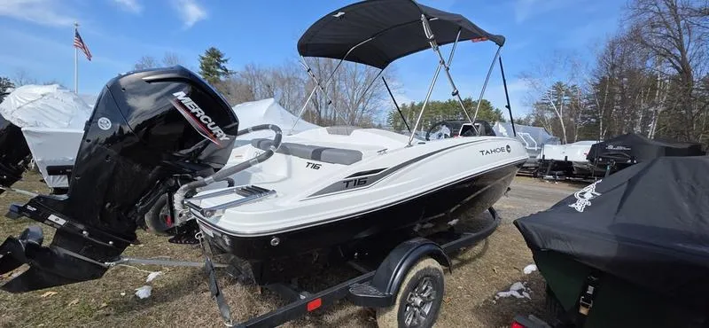 Slide: The Image of 2025 Tahoe T16 boat with Mercury outboard motor, parked outdoors under a blue sky. - 4