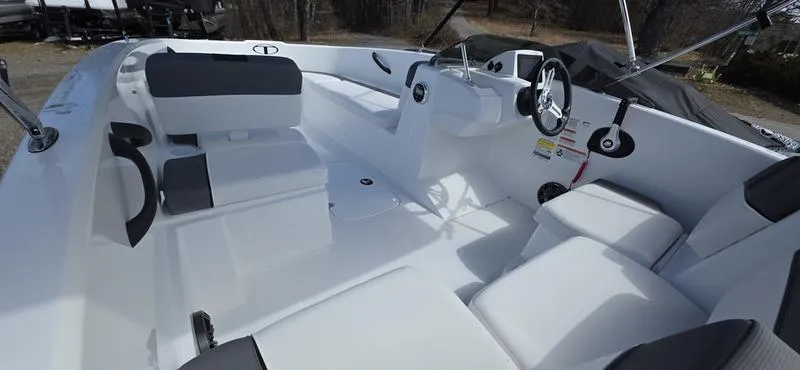 Slide: The Image of 2025 Tahoe T16 boat interior with white seating and steering wheel. - 7