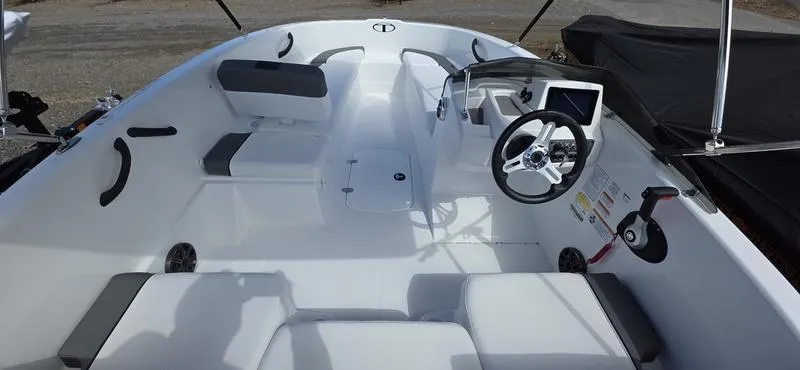 Slide: The Image of 2025 Tahoe T16 boat interior with steering wheel and seating arrangement. - 9