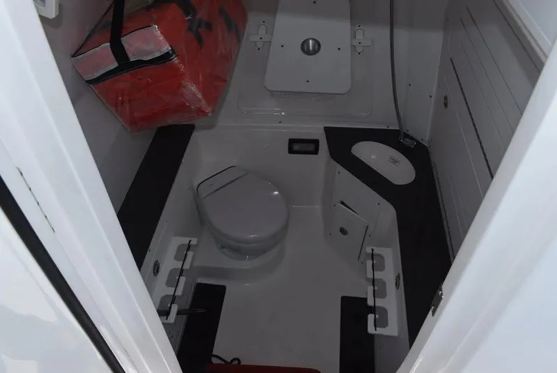 Slide: The Image of 2024 Crevalle 33 CSF boat interior with toilet and storage compartments. - 10