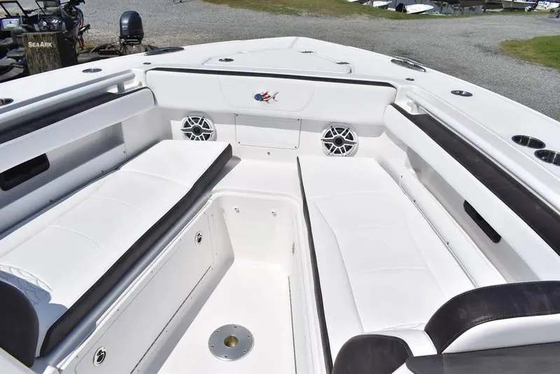 Slide: The Image of 2024 Crevalle 33 CSF boat interior with white seating and speakers. - 11