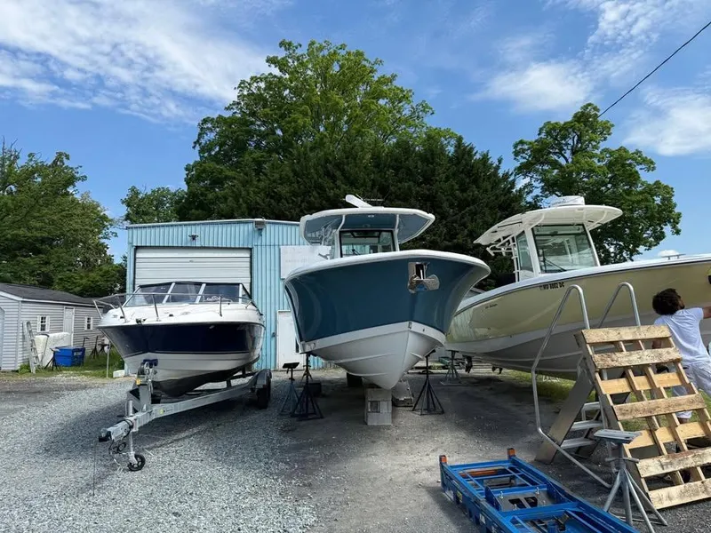 Slide: The Image of 2024 Crevalle 33 CSF boat in storage yard with other boats, under a partly cloudy sky. - 12