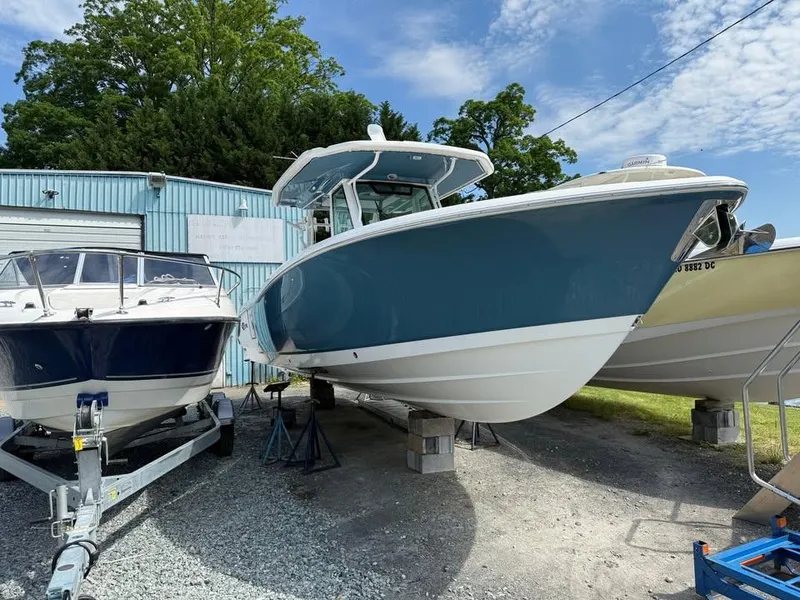Slide: The Image of 2024 Crevalle 33 CSF boat displayed outdoors near other vessels. - 3