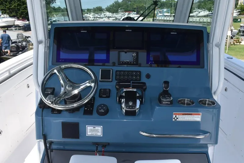 Slide: The Image of 2024 Crevalle 33 CSF boat dashboard with steering wheel and control panel. - 5