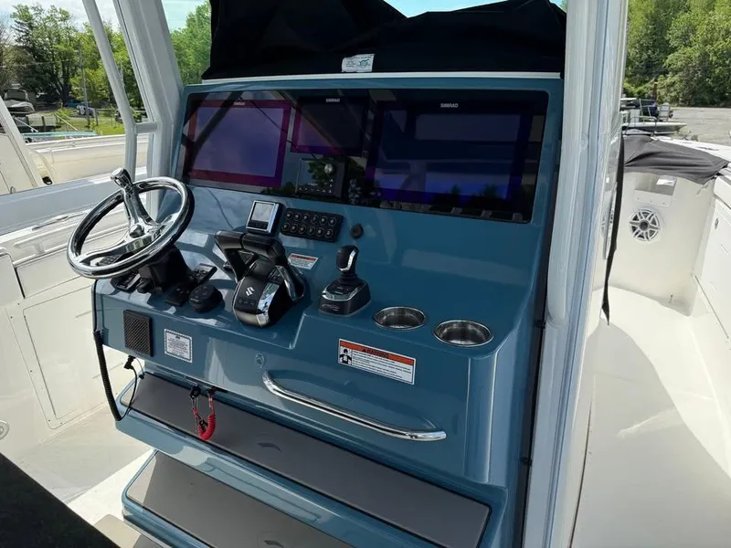 Slide: The Image of 2024 Crevalle 33 CSF boat dashboard with steering wheel and control panel. - 6
