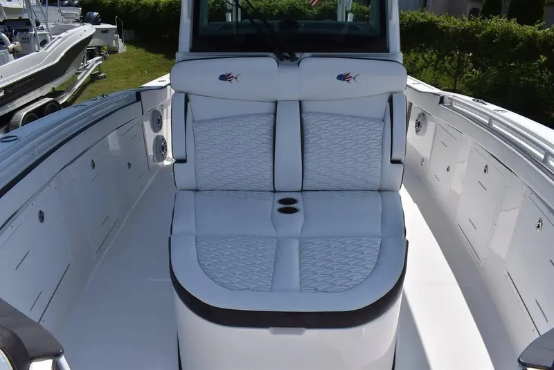 Slide: The Image of 2024 Crevalle 33 CSF boat with white cushioned seating and sleek design. - 7