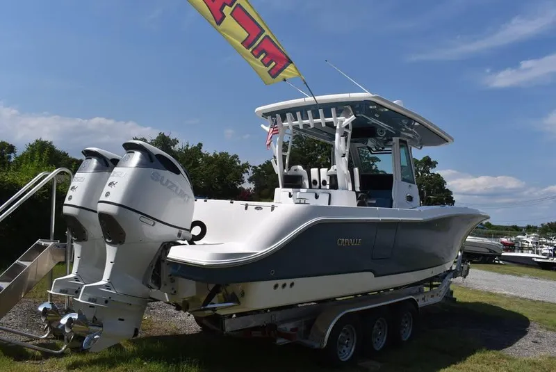 Slide: The Image of 2024 Crevalle 33 CSF boat with dual engines on a trailer, outdoors. - 8