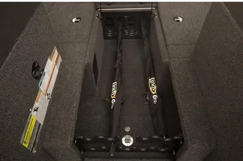 Slide: The Image of 2023 Alumacraft Trophy 185 boat interior storage compartment with rod holders and carpeted finish. - 15