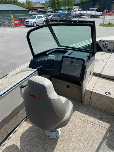 Slide: The Image of 2023 Alumacraft Trophy 185 boat interior with steering console and seating. - 3